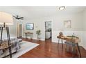 Bright living room featuring hardwood floors, modern decor, and an open doorway to the kitchen at 1120 Starline Se Dr, Smyrna, GA 30080