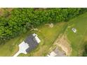 Aerial view showcasing the sprawling lot with mature trees surrounding a modern home at 1604 Greendale Rd, Covington, GA 30014