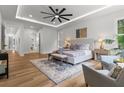 Sunlit main bedroom with a sitting area, wood floors, and neutral decor at 1604 Greendale Rd, Covington, GA 30014