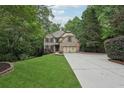 Charming two-story brick home with a well-manicured lawn and a spacious driveway at 1917 Oak Grove Ne Rd, Atlanta, GA 30345