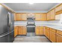 Bright kitchen with stainless steel appliances and wood cabinets at 4426 High Gate Nw Dr, Acworth, GA 30101
