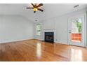 Inviting living room with hardwood floors, fireplace, ceiling fan, and lots of natural light at 4426 High Gate Nw Dr, Acworth, GA 30101