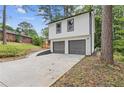 Exterior view of a two-story home with a spacious driveway leading to a two-car garage at 4847 Royal Dr, Duluth, GA 30096