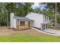Inviting two-story home featuring a cozy front porch and a neatly landscaped yard at 4847 Royal Dr, Duluth, GA 30096