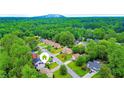 Expansive aerial view of neighborhood homes, surrounded by lush green trees and landscaping, with a mountain in the distance at 1012 Chapman Cir, Stone Mountain, GA 30088