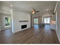 Spacious living room features a modern fireplace, shiplap accent wall, and hardwood floors throughout at 157 Basil St, Cumming, GA 30040