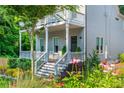 Beautiful two-story home with a covered porch and gorgeous landscaping featuring a variety of flowers and plants at 940 Longley Nw Ave, Atlanta, GA 30318