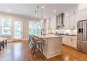 Modern kitchen with white cabinets, stainless steel appliances, and a large island with seating at 1964 Attell Way, Decatur, GA 30033