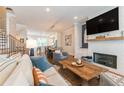 Open living room featuring a brick fireplace, television, and seamless access to the kitchen at 1964 Attell Way, Decatur, GA 30033