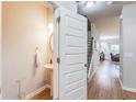 Stylish powder room featuring a pedestal sink, a round mirror, and modern fixtures, conveniently located near the entrance at 5525 Sable Way, Atlanta, GA 30349
