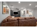 Open concept living area with hardwood floors, a view to the kitchen, and a large comfortable sectional sofa at 6980 Roswell Rd # B13, Sandy Springs, GA 30328