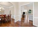 Elegant dining room with hardwood floors, wainscoting, and an open view to the living room at 997 Thousand Oaks Nw Bnd, Kennesaw, GA 30152