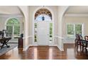 Grand foyer with arched entryway, hardwood floors, and natural light streaming through large windows at 997 Thousand Oaks Nw Bnd, Kennesaw, GA 30152