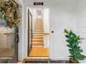 Bright foyer showcasing hardwood floors, leading to stairs, with white walls and decor at 395 Pratt Drive Se # No 802, Atlanta, GA 30315