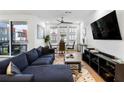 Inviting living room featuring a comfortable blue sectional sofa, large windows and hardwood floors at 395 Pratt Drive Se # No 802, Atlanta, GA 30315