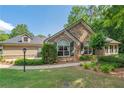 Attractive home with stone and siding accents, complemented by mature trees and manicured lawn at 5336 Stone Village Nw Cir # 2, Kennesaw, GA 30152