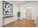 Bright entryway with hardwood floors, elegant console table, and modern artwork at 1995 Mcafee Rd, Decatur, GA 30032