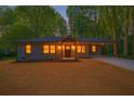 Charming single-story home featuring a cozy front porch, warm lighting, and a welcoming entrance at 1995 Mcafee Rd, Decatur, GA 30032