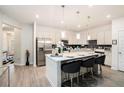 Open kitchen with modern island, stainless steel appliances, and sleek, contemporary lighting at 2140 Ravencliff Dr, Austell, GA 30168