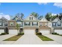 Attractive exterior of newly built townhomes showcasing varied colors and attached garages at 2140 Ravencliff Dr, Austell, GA 30168