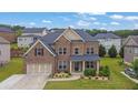 Beautiful brick home featuring a well-maintained lawn and garden, creating an inviting curb appeal at 2740 Longacre Park Way, Lawrenceville, GA 30044