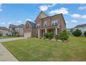 Attractive brick home with a well-kept lawn and landscaped garden at 2740 Longacre Park Way, Lawrenceville, GA 30044