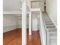 Bright, white entryway featuring a stairway with carpet runner, and an open living and dining space at 1097 Soaring Way, Marietta, GA 30062