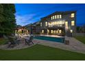 Inviting backyard with a sparkling pool, outdoor seating, and a cozy fire pit area at 3330 Riverwalk Way, Cumming, GA 30040