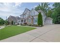 Beautiful two-story home featuring stone and siding accents with a well-manicured lawn at 3330 Riverwalk Way, Cumming, GA 30040