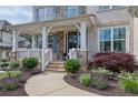 Charming front porch with stone accents, manicured landscaping, and a welcoming entrance at 3330 Riverwalk Way, Cumming, GA 30040