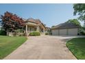 Well-maintained home featuring lush green lawn and a three-car garage with ample parking space at 105 Whippoorwill Way, Fayetteville, GA 30215