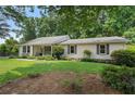 Single-story home showcasing a well-kept lawn and inviting exterior with classic architectural details at 290 Dania Dr, Alpharetta, GA 30009