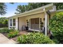 Covered front porch with seating, stylish double doors, and beautiful landscaping at 290 Dania Dr, Alpharetta, GA 30009