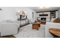 Open concept living room boasts fireplace with seating area and wood accents at 290 Dania Dr, Alpharetta, GA 30009
