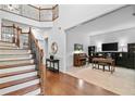 Elegant foyer with hardwood floors, staircase with wrought iron railings, and views into the living spaces at 910 Ovalene Sw Ln, Marietta, GA 30064
