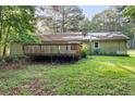The backyard features a wooden deck and a grassy lawn, perfect for outdoor enjoyment at 1757 Mystery Sw Cir, Conyers, GA 30094