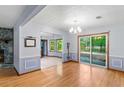 Open-concept living room with wood floors, stone fireplace, and sliding doors leading to the deck at 1757 Mystery Sw Cir, Conyers, GA 30094