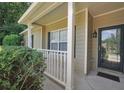 Inviting front porch with decorative columns and a stylish front door at 5600 Walnut Creek Nw Ct, Lilburn, GA 30047