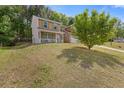 Charming two-story home with a well-maintained lawn and mature trees in a suburban setting at 1450 Steam Engine Way, Conyers, GA 30013