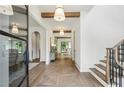 Welcoming foyer featuring hardwood floors, elegant lighting, and a staircase with black accents at 225 River Valley Ct, Atlanta, GA 30328