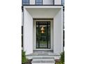 Elegant front door with stone steps, offering a glimpse into the home's sophisticated design at 225 River Valley Ct, Atlanta, GA 30328