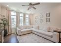 Cozy living area with a large sectional sofa, bright windows, and dark wood flooring at 3693 Allegretto Cir, Atlanta, GA 30339