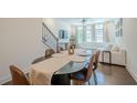 Open-concept dining and living area with hardwood floors, a ceiling fan, and lots of natural light at 3693 Allegretto Cir, Atlanta, GA 30339