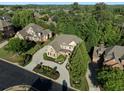 Aerial view of a large home with a circular driveway, lush landscaping, and mature trees at 8805 Marion Dr, Duluth, GA 30097