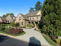 Lovely stone and brick home with well-maintained landscaping, a circular driveway and covered entry at 8805 Marion Dr, Duluth, GA 30097