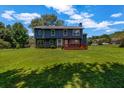 Expansive backyard view showing a large lawn, a deck, and the home's rear elevation at 2505 Tiffany Se Ct, Conyers, GA 30013