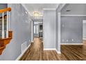 Hallway featuring hardwood floors, neutral gray walls, and a staircase with wooden banisters at 2505 Tiffany Se Ct, Conyers, GA 30013