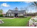 Community clubhouse featuring well-manicured lawn, flowering plants, and community pool at 3925 Tugaloo River Dr, Duluth, GA 30097