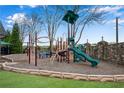 Community playground featuring various climbing structures, a slide, and a picnic table at 3925 Tugaloo River Dr, Duluth, GA 30097
