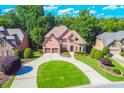 Impressive brick home boasts a manicured lawn, circular driveway and a two-car garage in a lovely neighborhood at 5675 Habersham Vly, Suwanee, GA 30024
